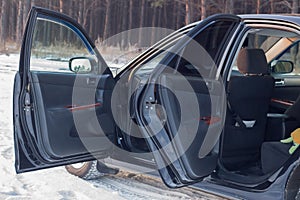 Details of the black car in the cabin, steering wheel, trunk, speedometer and open doors