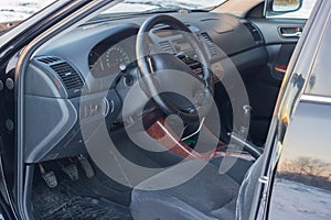 Details of the black car in the cabin, steering wheel, trunk, speedometer and open doors