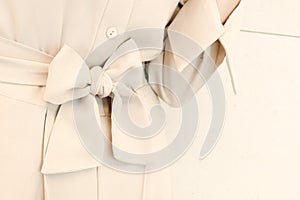 Details of bow belt tie in beige woman dress outfit style. trendy fashion.
