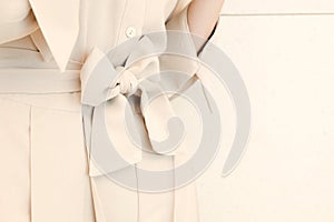 Details of bow belt tie in beige woman dress outfit style. trendy fashion.