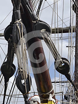 Details of bowsprit and pulleys on board vintage sailing ship.
