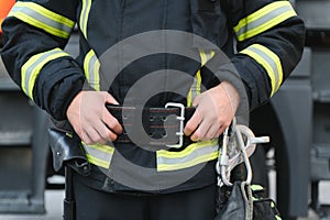 Details with the carabiner and harness of a firefighter