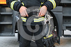 Details with the carabiner and harness of a firefighter