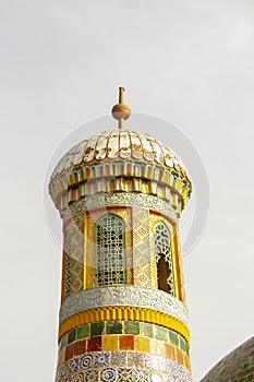 Carved wooden painted minaret at mosque, Mausolem of Apak Khoja, Kashgar, China photo