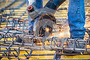 Details of construction engineer worker cutting steel bars and reinforced steel at building site