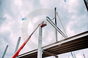 Details of construction site with crane lifting prefabricated concrete framework