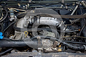 Details of a dirty diesel engine under the hood of a car