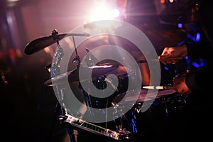 Details of a drum kit and a drummer stick at a rock concert