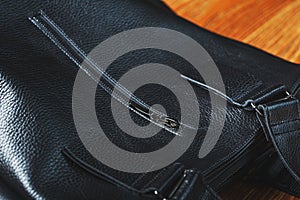 Details and elements of the bag are handmade from black leather, close-up, macro locks