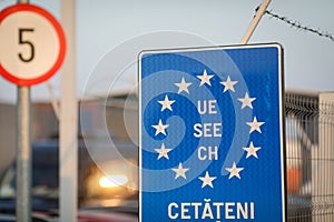 Details with an European Union flag and barbed wire at a Romanian border crossing
