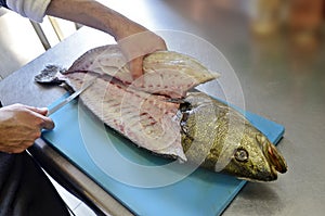 Details filleting fish on a cutting board