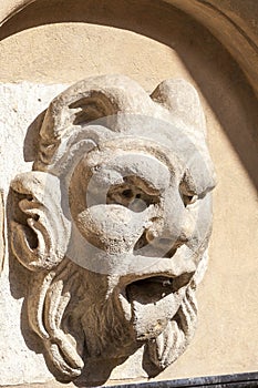 Details of fountain with mascaron in the courtyard of Collegium Maius, Krakow, Poland