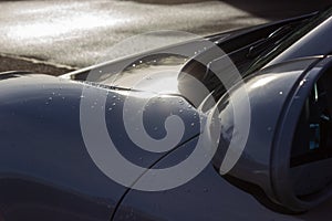 details of german sportscar body work with raindrops