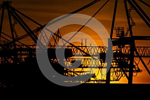 Details of gigantic container gantry cranes at sunset..