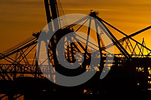 Details of gigantic container gantry cranes at sunset..