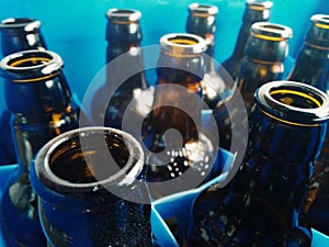 Details of glass bottles on blue plastic