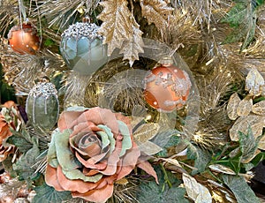 Details of golden christmas tree with rose and baubles