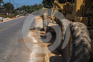 Details of grader is working on road construction. Grader industrial machine on construction of new roads. Heavy duty