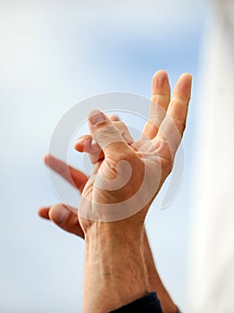 Details with the hand of a protestor showing the victory sign during a political rally