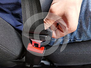 Details of hand putting on safety belt