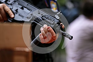 .Details with the hands of a man holding an automatic rifle