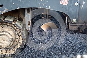 Details of industrial machinery working with asphalt, mixing bitumen with hot asphalt, layering on the road surface