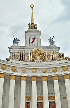 Details of the main pavilion of the Exhibition of Achievements of the national economy in Moscow: spire, sculptures, columns, coat