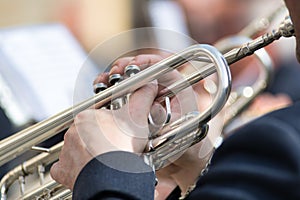 Details of man's hands playing the trumpet