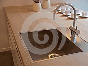Details of modern kitchen sink with tap faucet