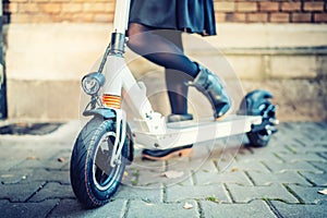 Details of modern transportation, electric kick scooter, Portrait of girl riding the city transportation photo