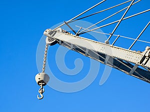 Details of an old crane: hook, chain, pulley, beam, rivets