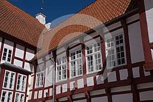 Details of old half timbered building with red tiles and casemate windows