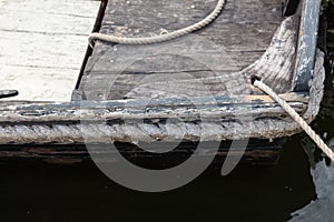 Details of old wooden boat with rope bumper, vintage boat construction details