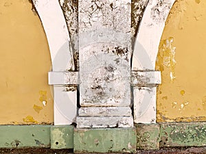 Old yellow white and green painted building exterior