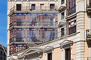Details of the one of old buildings with colored glasses in modern style in the historical center of Barcelona in sunny day. Spain