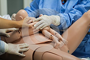 Details with plastic dummies representing a woman and her newly born baby used by medics and midwives for childbirth practice