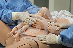 Details with plastic dummies representing a woman and her newly born baby used by medics and midwives for childbirth practice