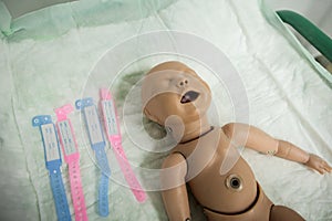 Details with a plastic dummy representing a newly born baby used by medics and midwives for childbirth practice