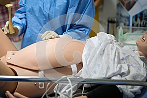 Details with a plastic dummy representing a woman giving birth used by medics and midwives for practice