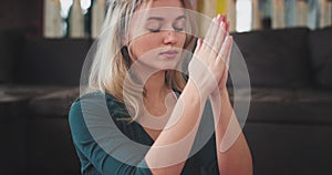 Details portrait of blonde woman meditation in the morning yoga practicing for a healthy lifestyle , at home in living