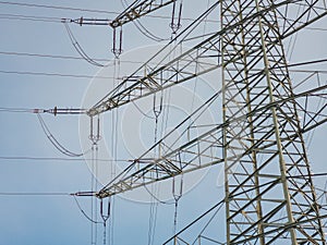 Details of a pylon of a high-voltage power line in front of a bl