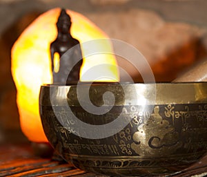 Singing bowl, Bouddha and himalayan salt lamp photo