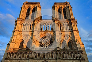 Details of the western facade of Notre Dame de Paris Cathedral facade with the oldest rose window and ornate tracery in the warm