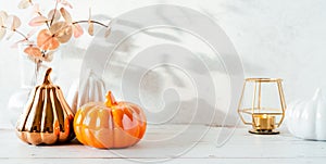 Details of Still life, cup of tea or coffee, pumpkins, candle, brunch with leaves on white table background, home decor