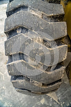 Details of the thick and heavy duty wheel of a yellow construction machine