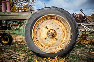 Details and tire on rusty old farm tractor