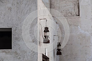 Petromax lamps hanging on the wall of Arabic heritage building. photo