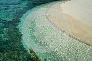 details of tropical beach with shades of water and coral