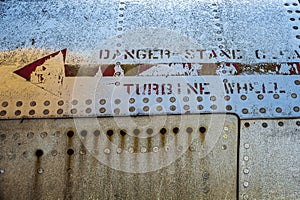 Details of a turbine wheel inscriptions on the side of a old airplane at The Montreal Aviation Museum