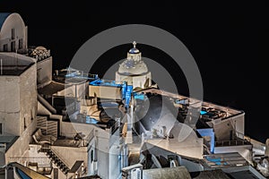 Details of typical buildings illuminated at night in Fira, the main town of Santorini, Greece